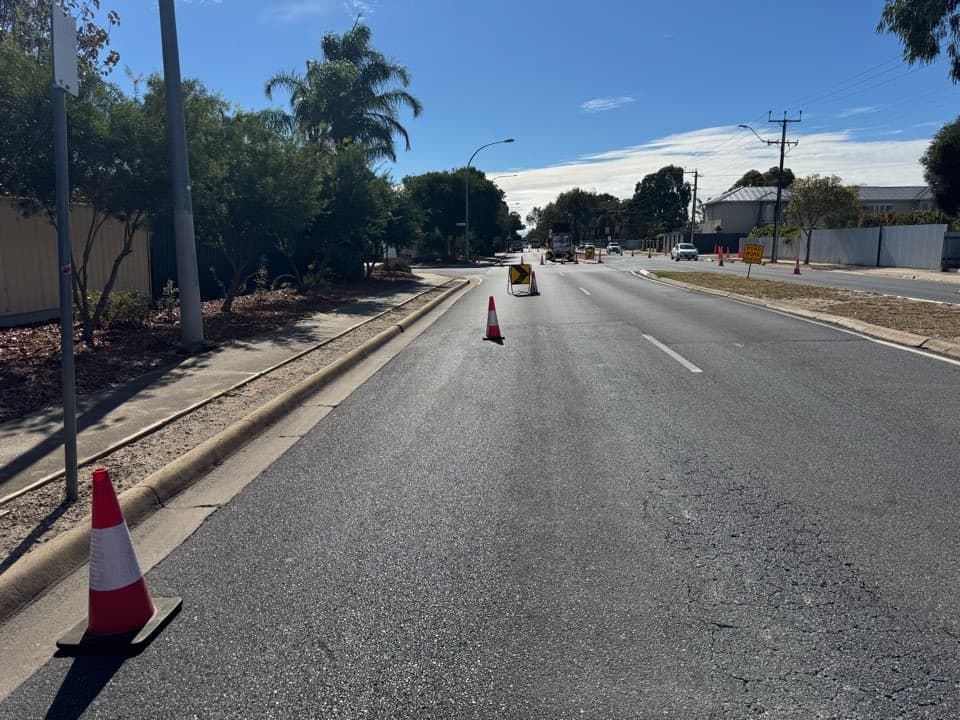 Chevron signage and cones deployed on a suburban street